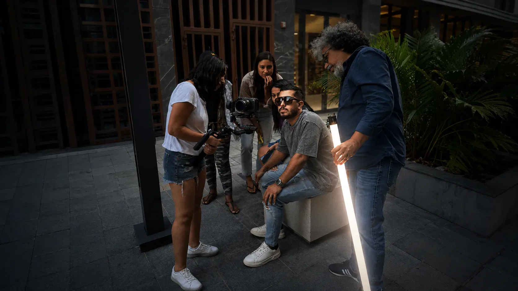 Sina Monfared collaborating with a production team on set